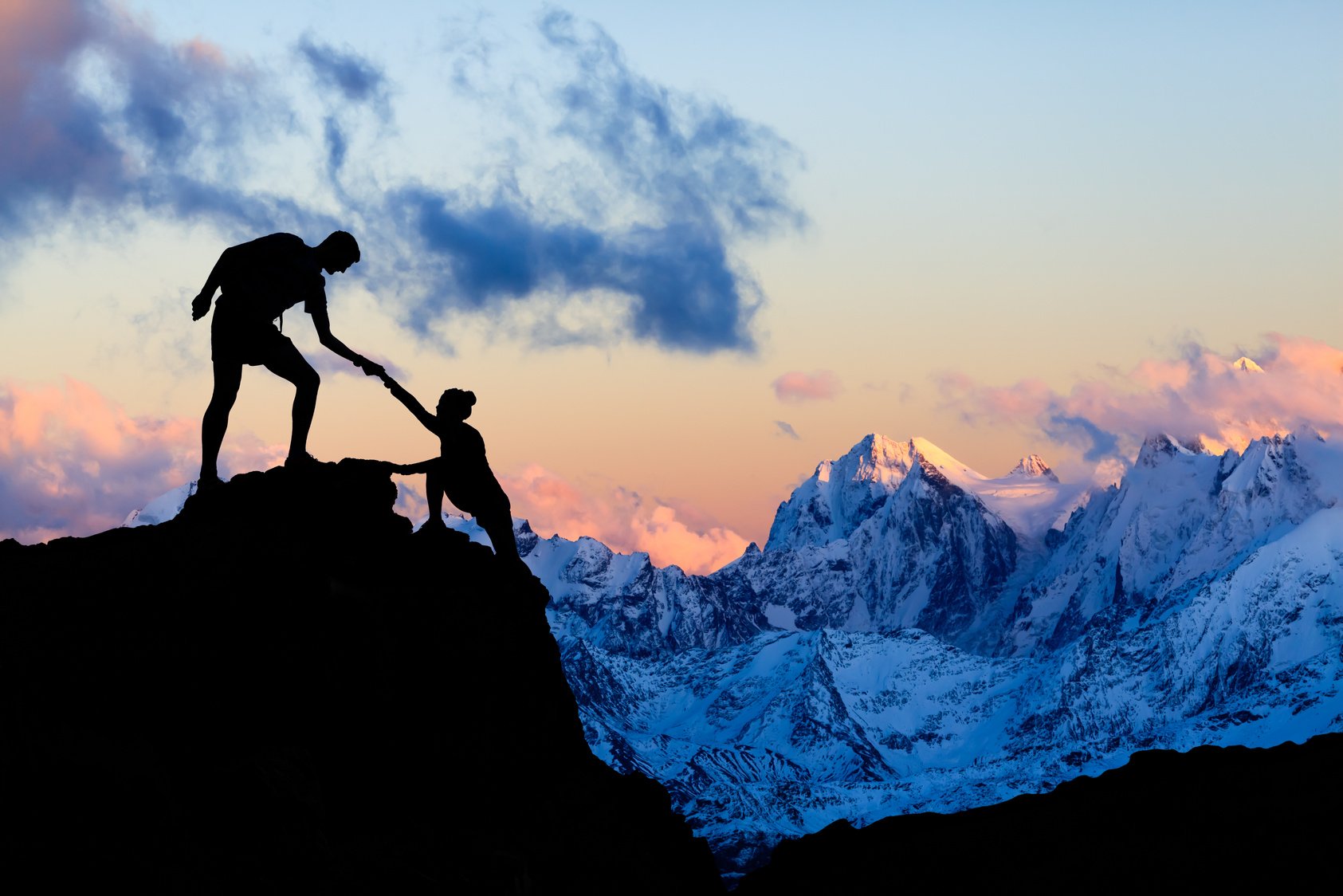 Teamwork couple helping hand, trust in mountains